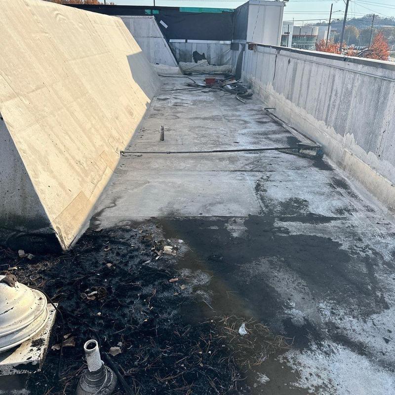 Commercial flat roof with storm damage and debris