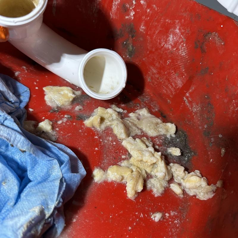 Sink drain pipe with cleared clog debris and cleaning cloth