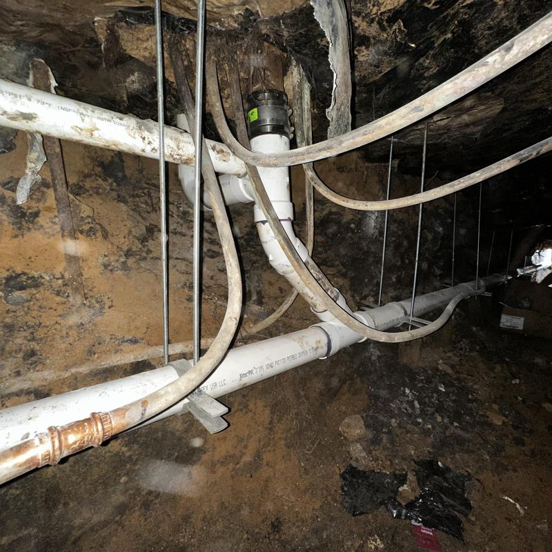 Schedule 40 PVC sewer piping with riser clamp supports