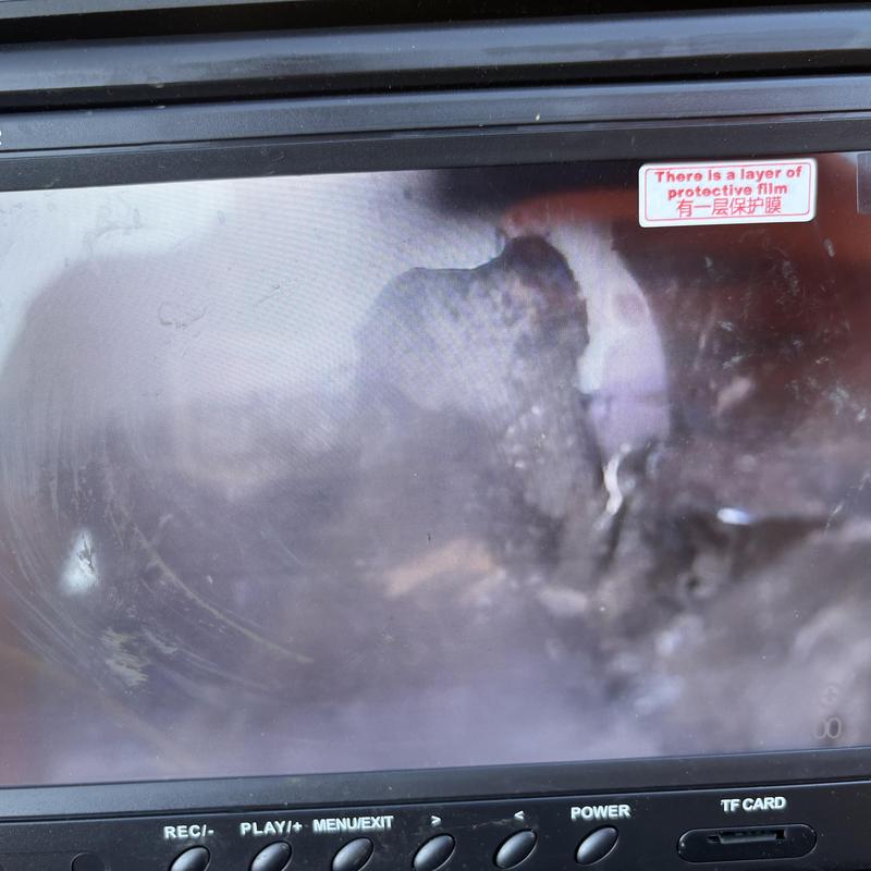 Sewer pipe interior with visible cracks on screen