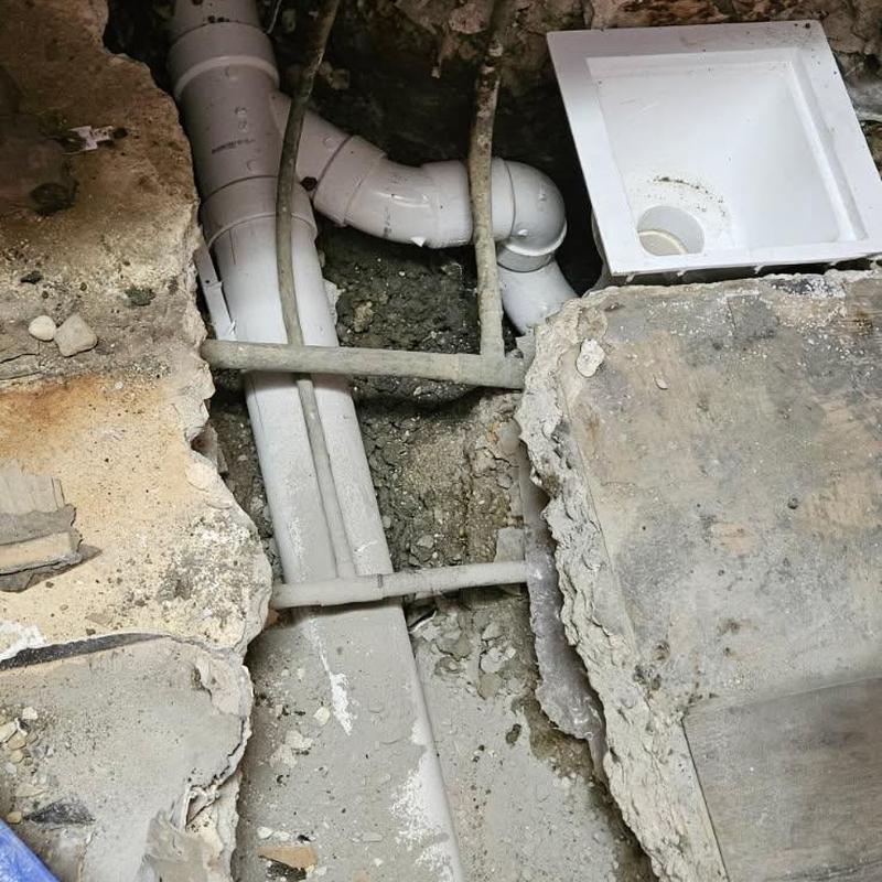 PVC drain line with floor access box in concrete floor