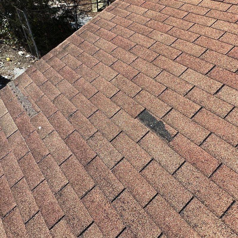 Asphalt shingle roof with storm damage inspection