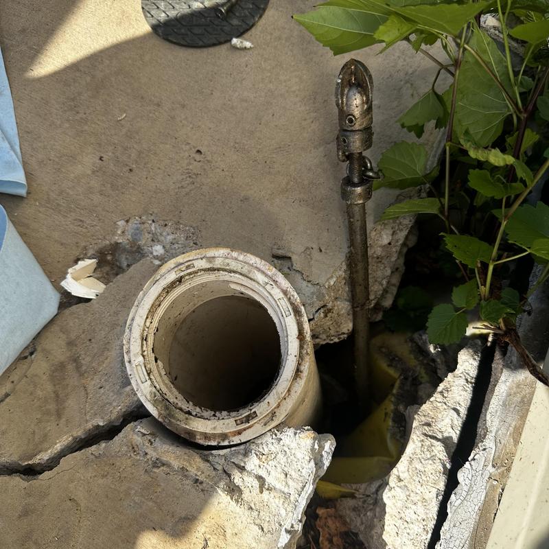 Cleanout pipe outside cracked in concrete slab