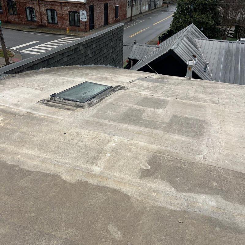 Flat roof surface with skylight and patch markings
