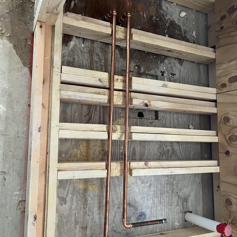 Copper shower lines capped near tub filler installation site