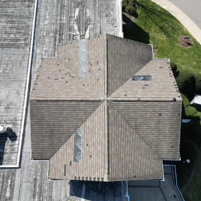 Asphalt shingle church roof with hail damage and repairs