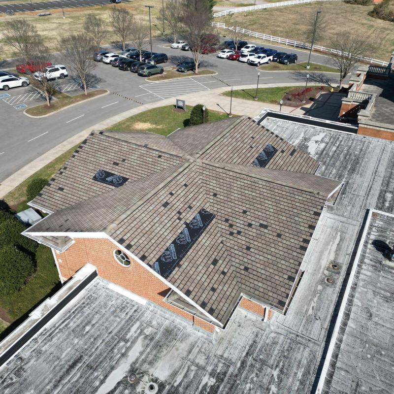 Church roof with hail damage and wind displacement