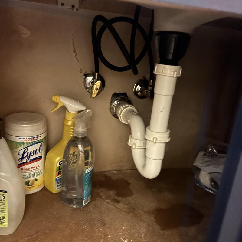 Sink drainage pipes and water shutoff valves under cabinet