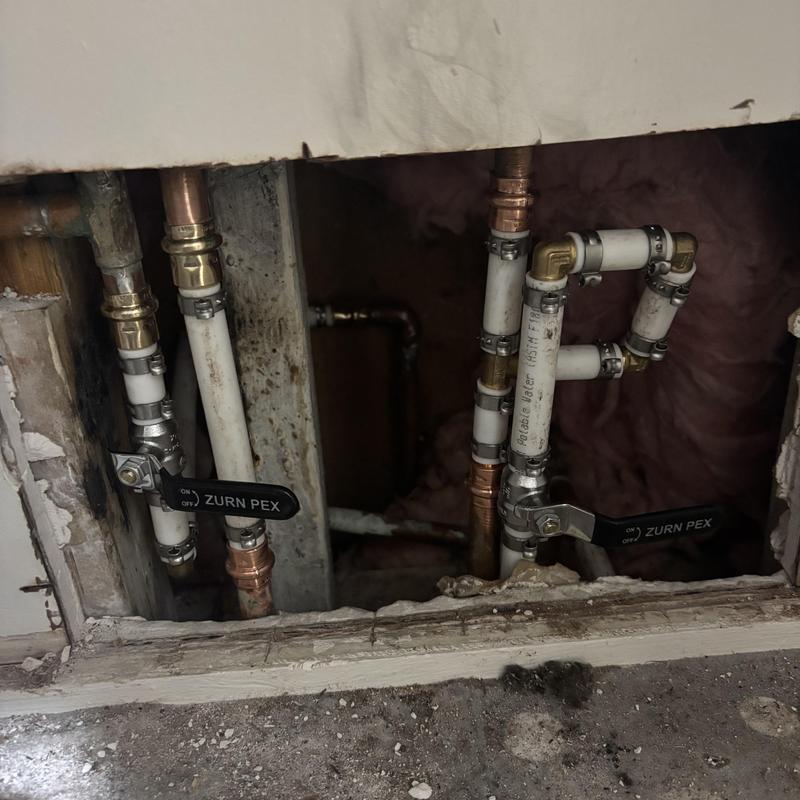 PEX piping with shutoff valves in wall cavity