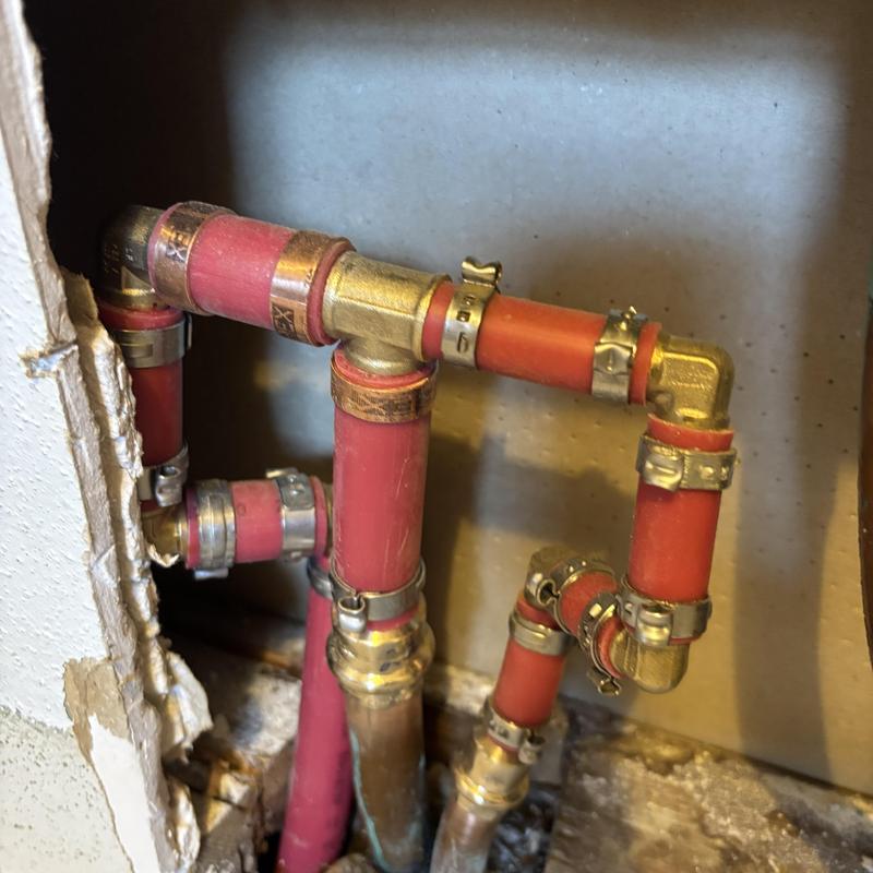 PEX-B piping with brass fittings in wall cavity