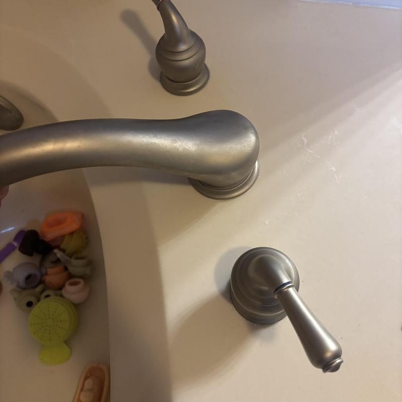 Bathtub faucet and handle on bathroom sink