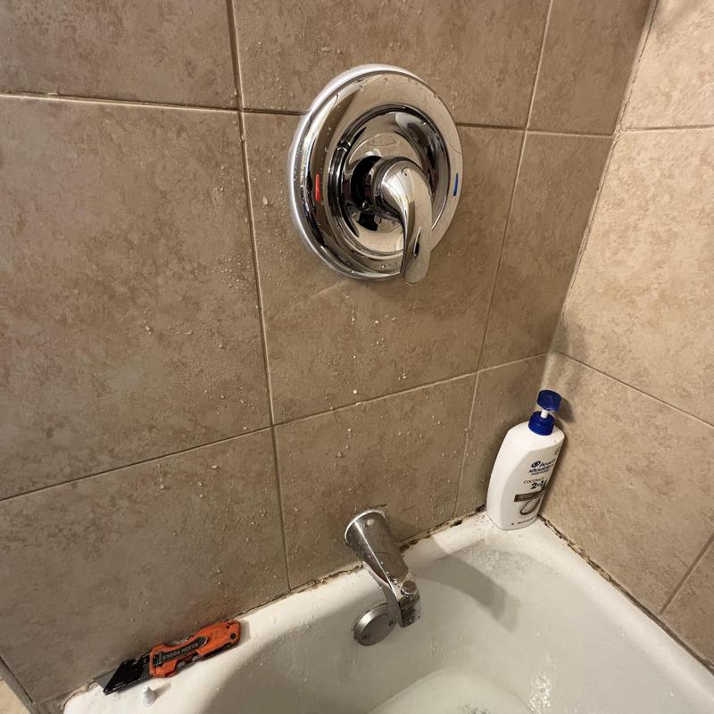 Shower valve replacement in tiled bathroom wall