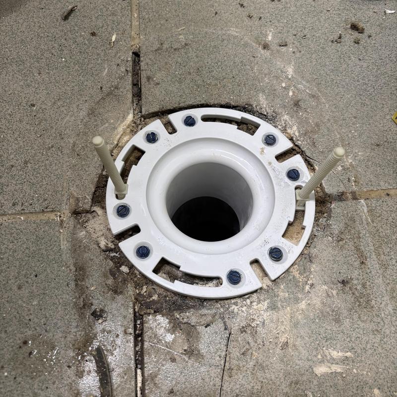 Toilet flange installed on bathroom floor tile