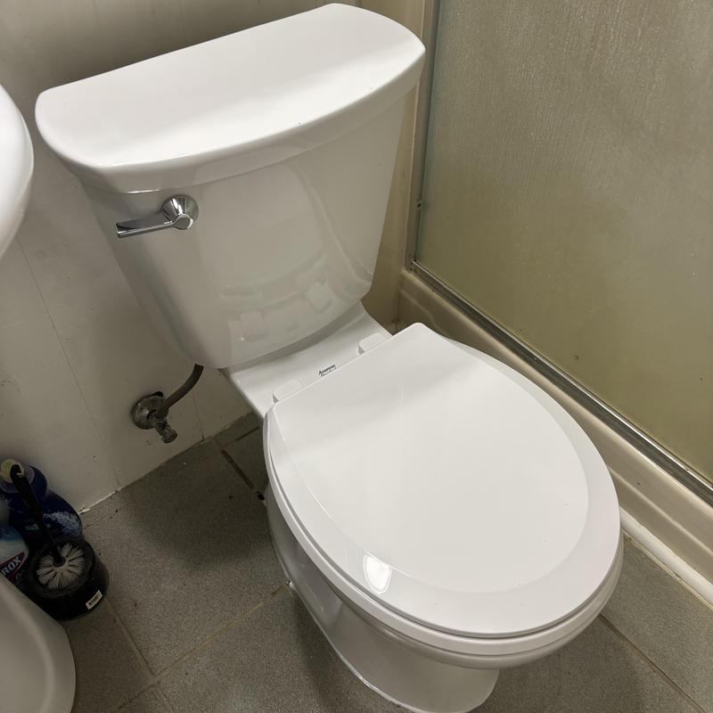 Toilet with new flange installed in bathroom corner