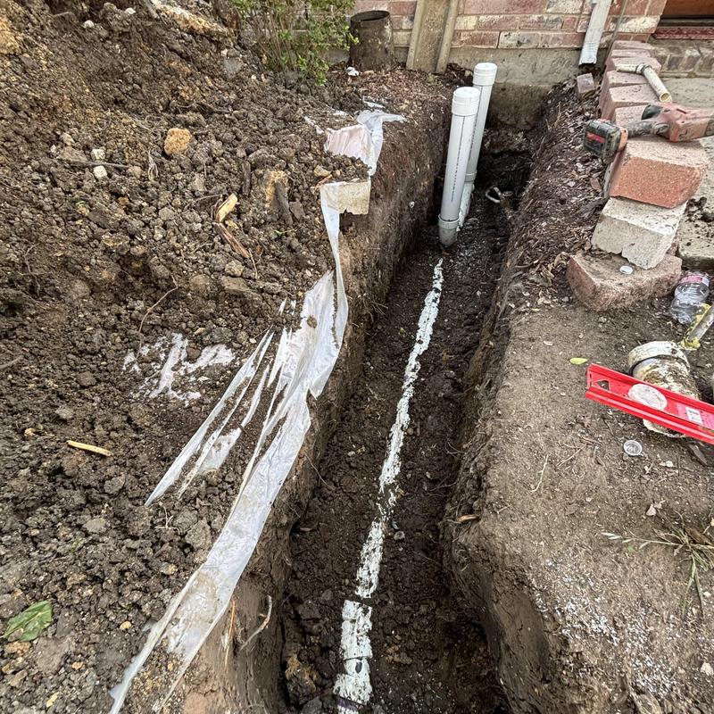 4-inch PVC main sewer line installation in trench