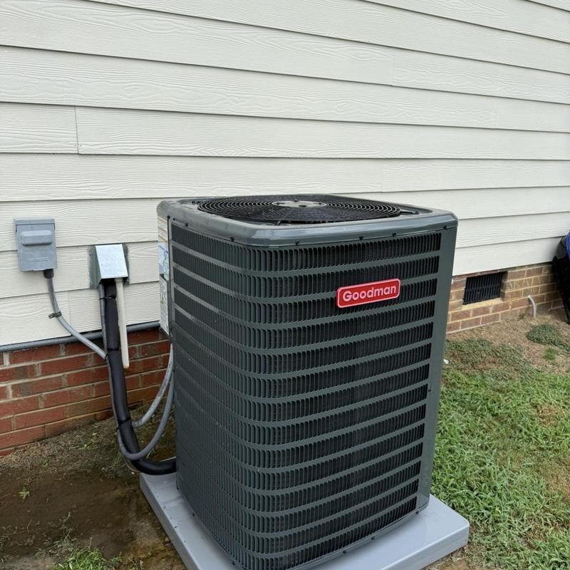 Goodman outdoor air conditioning unit on concrete pad