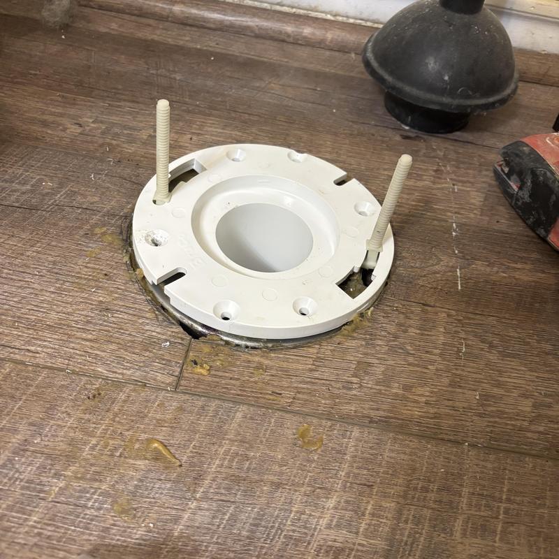 PVC toilet flange installed on wood floor