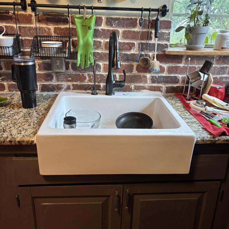 Kitchen sink with black faucet and granite counter