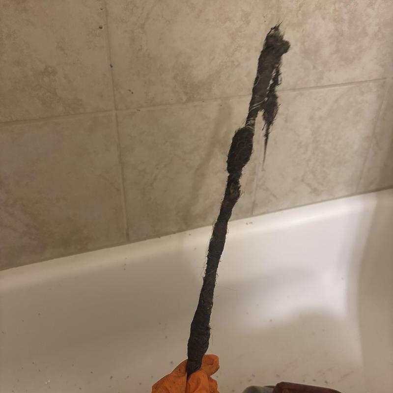 Bathtub drain clog with pulled out hair debris