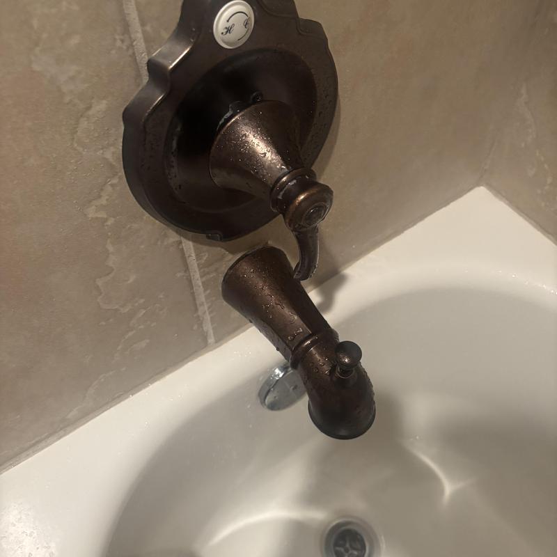 Tub spout and handle on bathtub wall