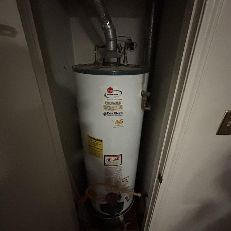Gas water heater with vent pipe in utility closet