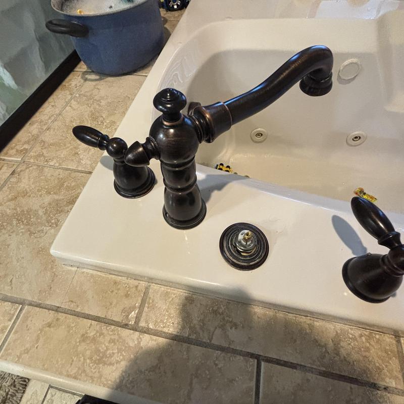 Bathtub faucet cartridge replacement in white tub