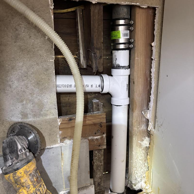 Schedule 40 PVC drain pipe with metal coupling in wall