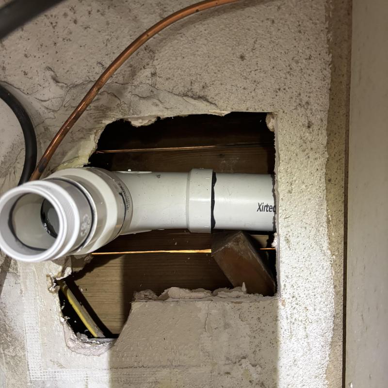 Schedule 40 PVC drain pipe installation in wall cutout