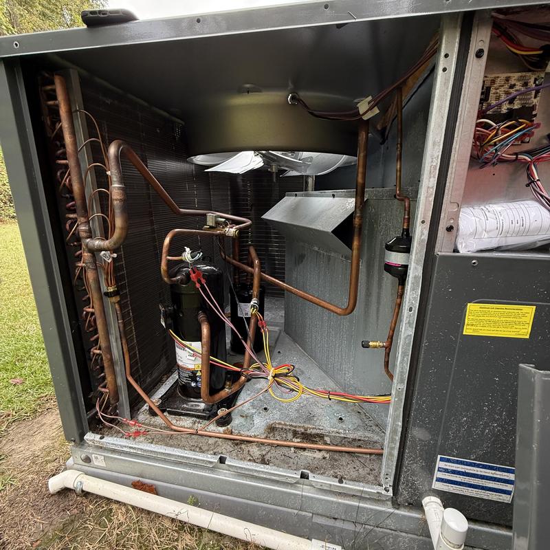 AC compressor and electrical connections inside unit