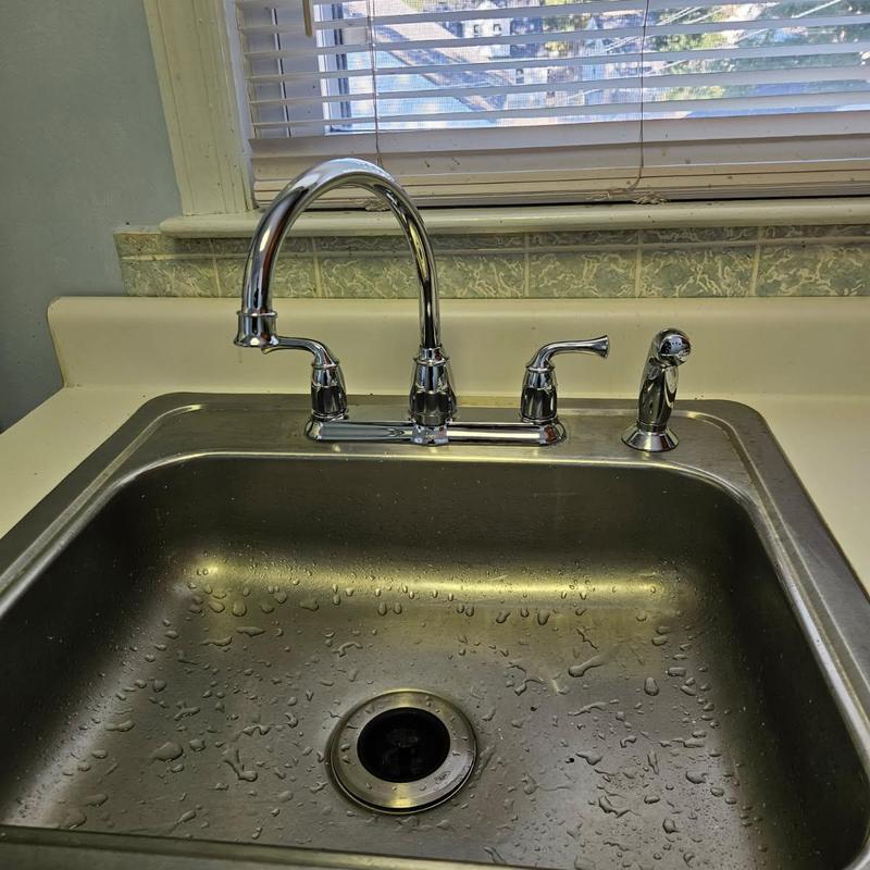 Kitchen faucet with side spray installed over sink