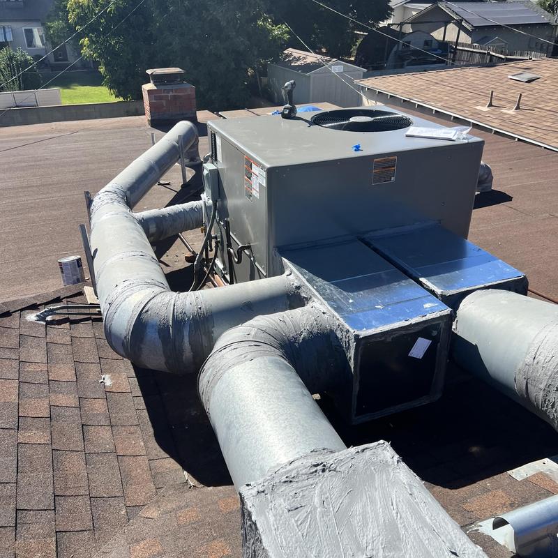 Packaged rooftop HVAC unit with ductwork installation