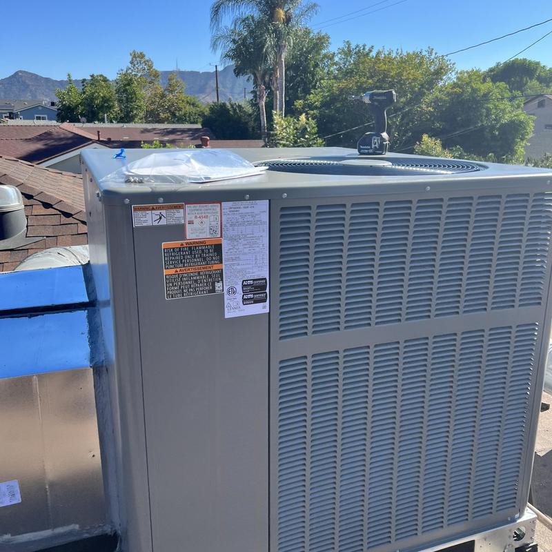 Packaged HVAC unit LRP15GX on rooftop with drill