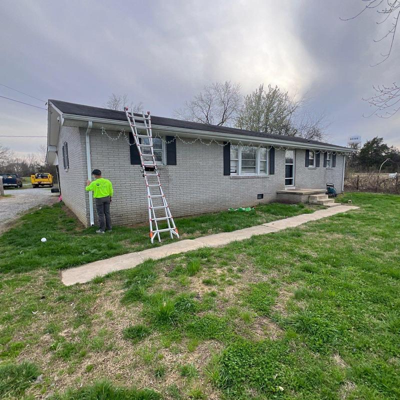 Asphalt shingle roof with inspection ladder and technician