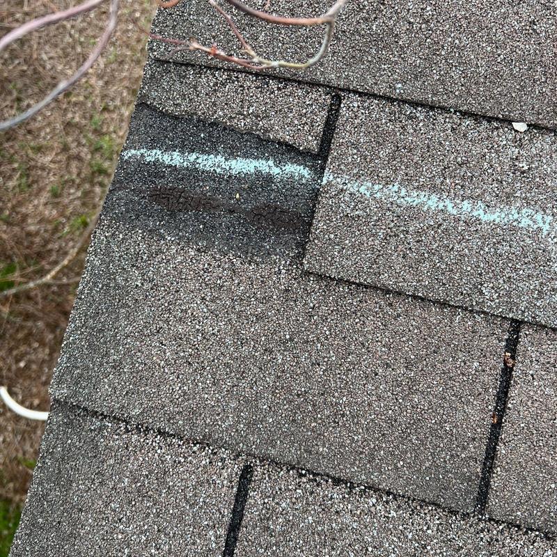Asphalt roof shingles with bruising and uplift damage