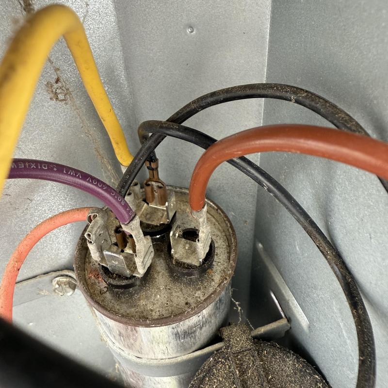 HVAC capacitor with connected colored wires inside unit