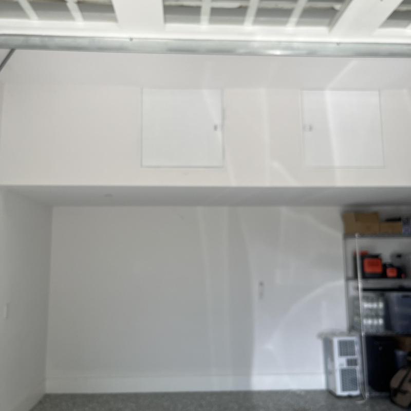 Wall access panels above garage storage shelves Wall access panels above garage storage shelves