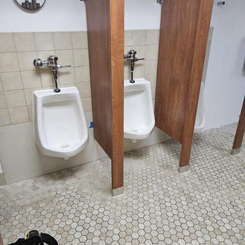 Urinals with privacy partitions in Pasadena bathroom