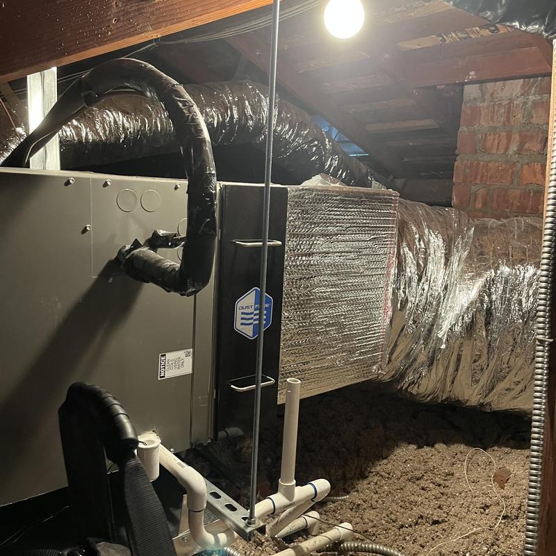 Furnace and ductwork in attic during maintenance