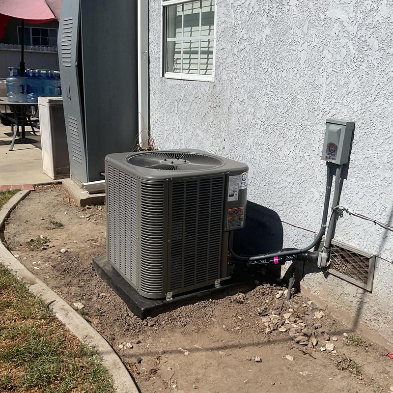 ML14KC1 condenser unit installed outdoors next to house