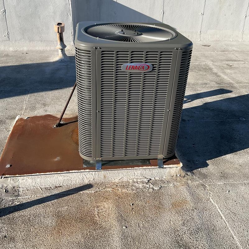Lennox heat pump unit on rooftop platform