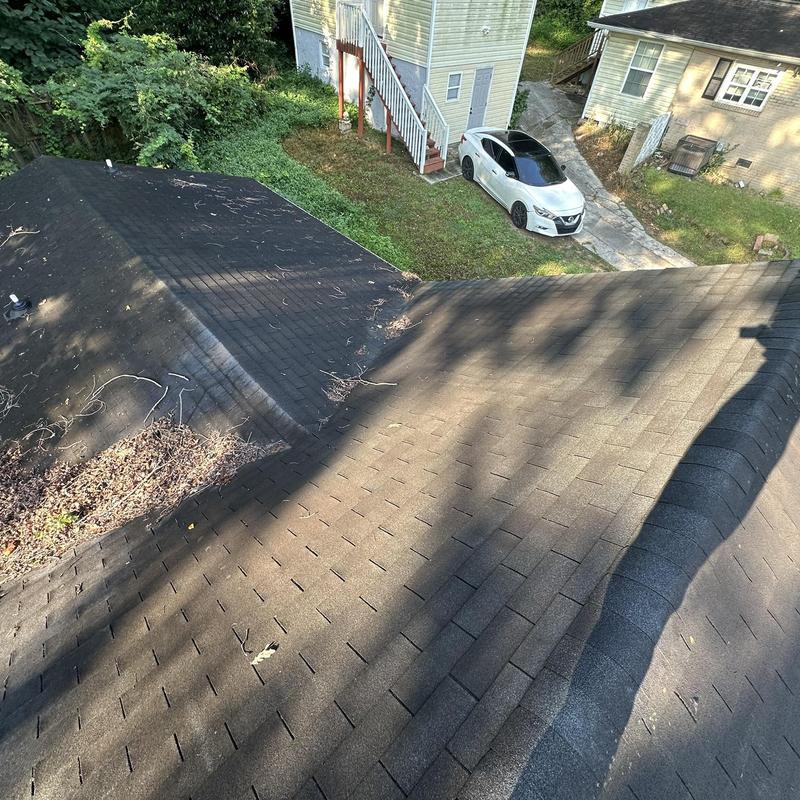 Asphalt shingle roof with valley and debris buildup