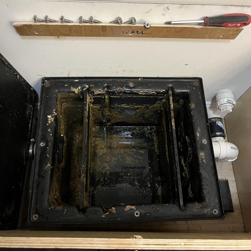 Grease trap interior before cleaning and maintenance