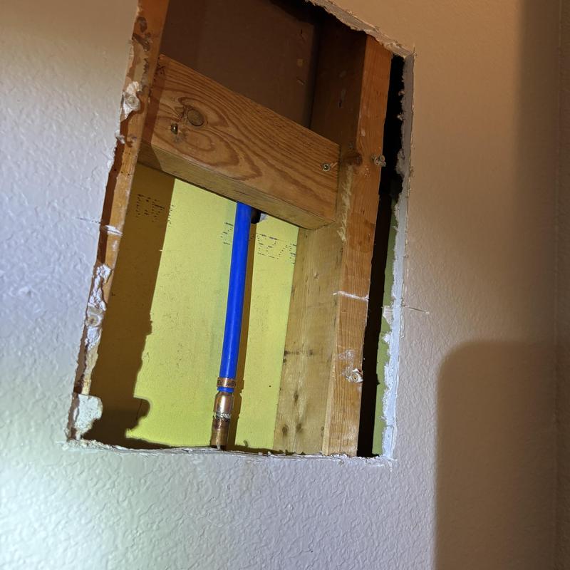 Shower arm and drop ear installation in wall cavity