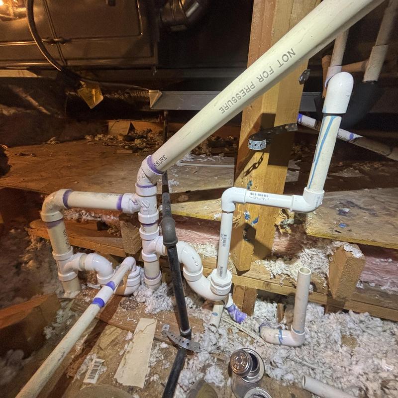 Condensate drain line reroute in attic plumbing system