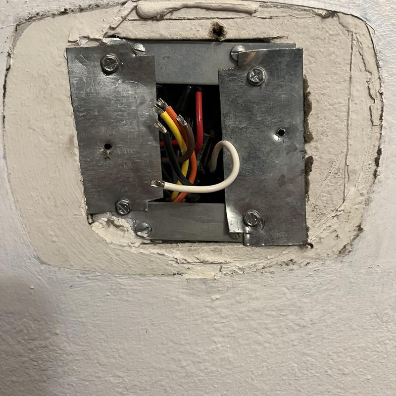 Thermostat wiring junction box with exposed wires