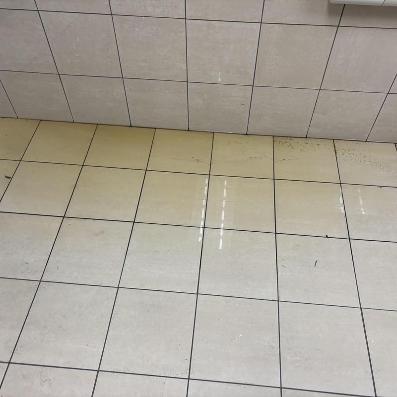 Tile floor grout with dirt and discoloration