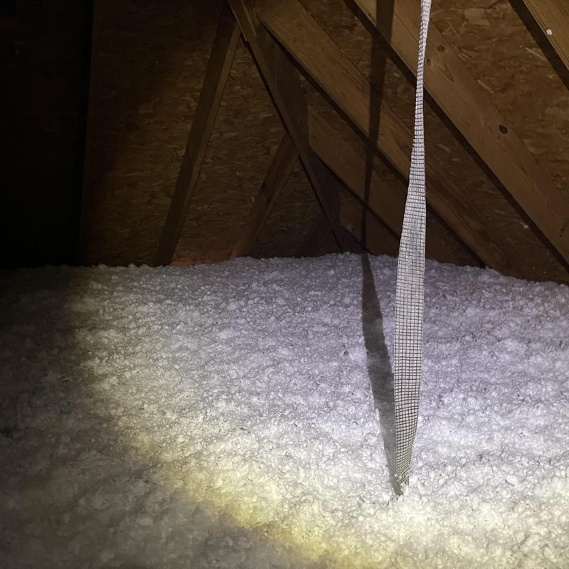 Attic insulation loose-fill installed beneath roof rafters Attic insulation loose-fill installed beneath roof rafters