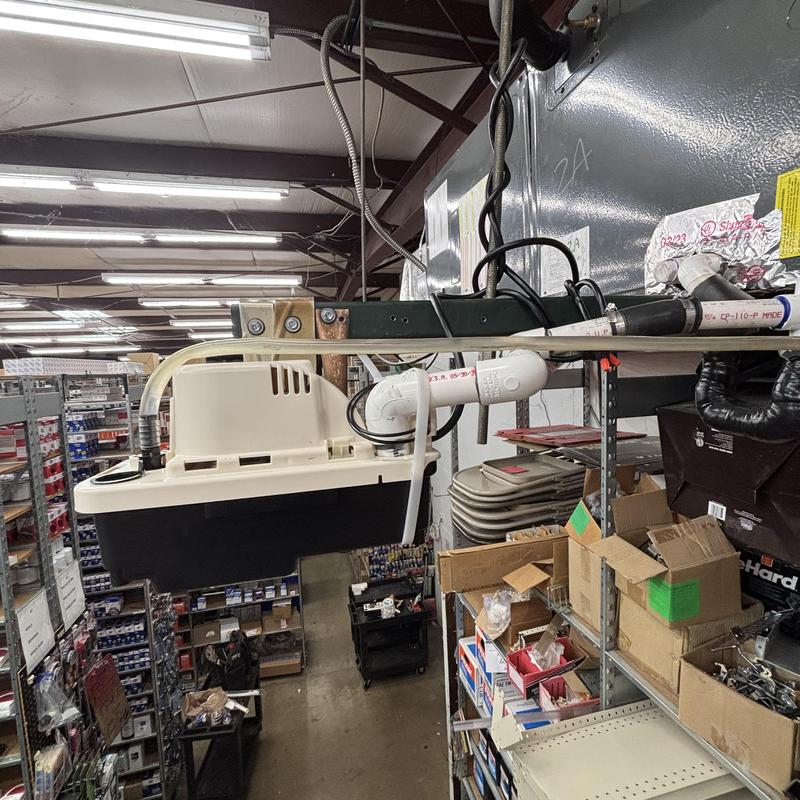 Condensate pump installation in warehouse HVAC system