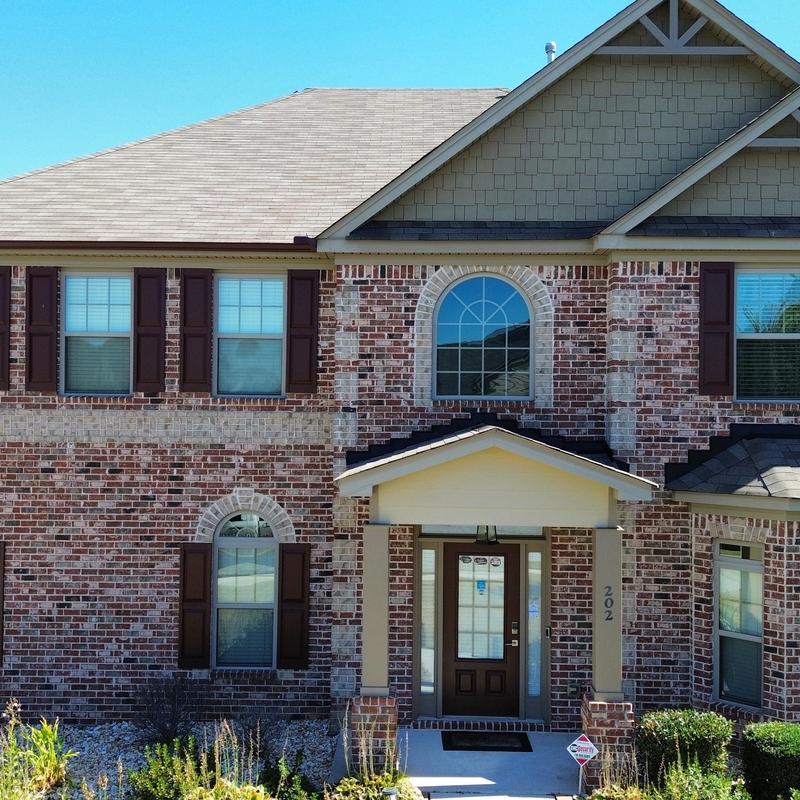 TAMKO TITAN XT roof replacement on brick house facade