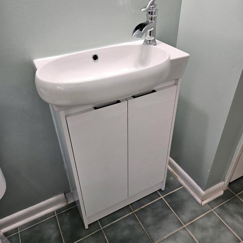 Bathroom vanity with faucet installed on tiled floor